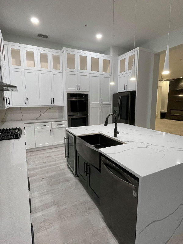 kitchen interiors remodeled with wooden white cabinetry and marble countertops naples fl